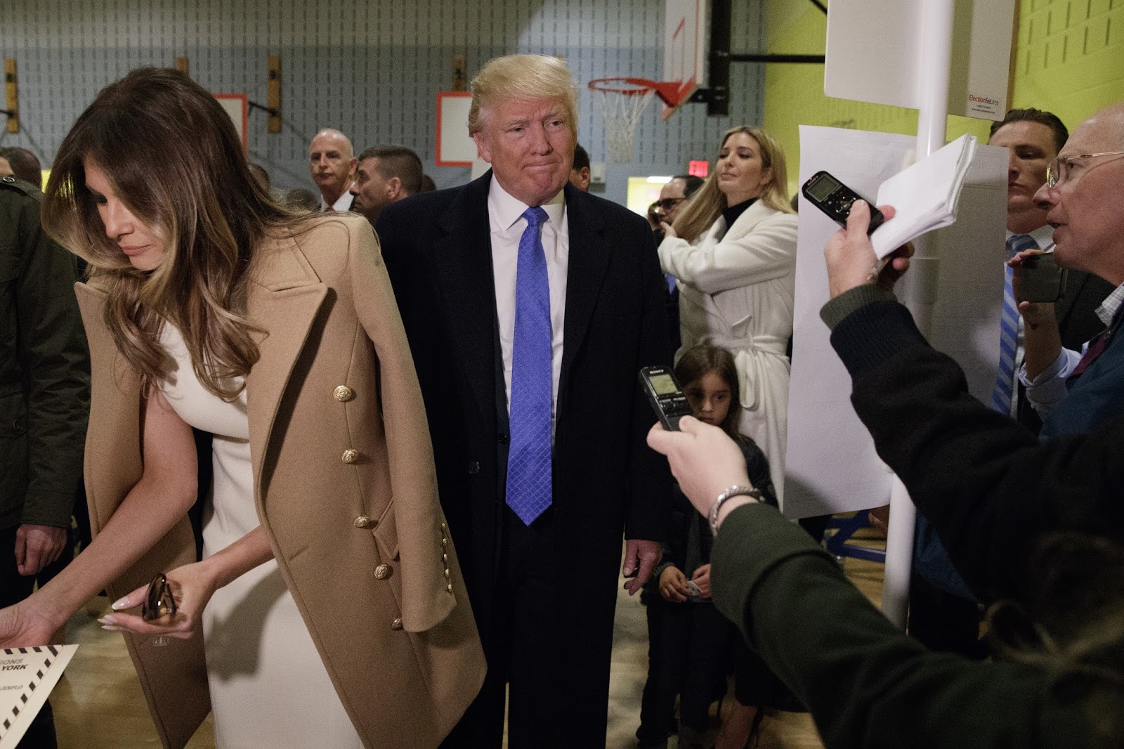 Republican presidential candidate Donald Trump, accompanied by his wife Melania, talks with reporters as he waits in line to vote at PS-59, Tuesday, Nov. 8, 2016, in New York. (AP Photo/ Evan Vucci) |
